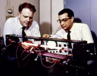 Early Gas Laser: William Ralph Bennett, Jr. and Ali Javan work with a helium-neon optical gas maser at Bell Laboratories. Their laser was first tested on December 12, 1960. The next day, they used it to transmit the first telephone conversation across a laser beam. 