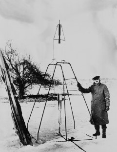Dr. Robert H. Goddard and His Rockets: Dr. Goddard and liquid oxygen-gasoline rocket in the frame from which it was fired on March 16, 1926, at Auburn, Massachusetts. It flew for only 2.5 seconds, climbed 41 feet, and landed 184 feet away in a cabbage patch. From 1930 to 1941, Dr. Goddard made substantial progress in the development of progressively larger rockets, which attained altitudes of 7800 feet.