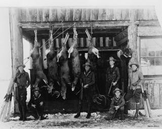 Ranch school students display their hunting success: Hunting expeditions were a regular occurrence at the Ranch school. Six students stand or kneel before their captures.