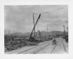 Main Street in Hiroshima: The center of Hiroshima after the dropping of the atomic bomb on August 6, 1945.  The street indicated in this photograph is approximately one half (.5) mile from the location where the bomb was detonated indicating the extent of the devastation to the city’s buildings and roads.