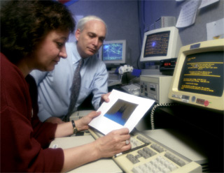 Reviewing Data From the Burst and Transient Source Experiment (BATSE): Dr. Gerald Fishman (Marshall Space Flight Center), and his colleague Dr. Chryssa Kouveliotou (Universities Space Research Associates) review data from the the Burst and Transient Source Experiment (BATSE).  Dr. Fishman was the Principal Investigator of the BATSE instrument, aboard the Compton Gamma-Ray Observatory's (CGRO).