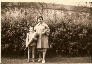 Dieter Hartmann as a child: Dieter Hartmann stands next to his mother on his first day of school holding an Easter cone full of candy.