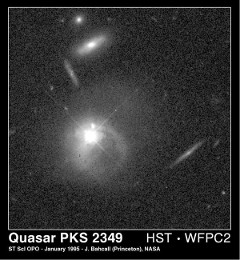 Quasar and Companion Galaxy: The bright central object is a quasar that is merging with its companion galaxy.