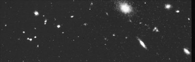 Distant Galaxy Clusters: One of Hubble's early images reveals about 30 compact objects that are among the faintest (oldest) galaxies observed at the time (in 1992).
