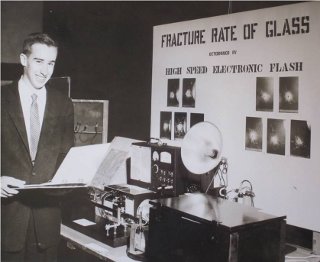 Blair Savage at the 1959 Westchester County Science Fair: The ultra high-speed flash equipment Professor Savage used to determine the fracture rate of glass. Two very closely spaced flashes of duration of one millionth of a second were obtained after the glass was broken by a bullet. The distance the crack in the glass moved between the two flashes yielded the velocity of the crack.