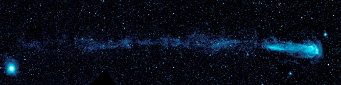 GALEX Captures a Shooting Star: Even though Ultraviolet imaging surveys were not critical to the progress of UV spectroscopy for 35 years, once GALEX was launched in 2003 it made major discoveries, enabling new views of the Universe. The Galaxy Evolution Explorer (GALEX) shows a speeding star that is leaving an enormous trail of material that will be recycled into new stars, planets and possibly even life as it hurls through our Galaxy. Mira appears as a small white dot in the bulb-shaped structure at right, and is moving from left to right in this view. The shed material can be seen in light blue. The dots in the picture are stars and distant galaxies. The large blue dot at left is a star that is closer to us than Mira. When astronomers first saw the picture, they were shocked because Mira has been studied for over 400 years yet nothing like this has ever been documented before.