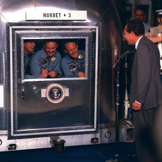 President Nixon Visits Apollo 11 Crew in quarantine: President Richard M. Nixon welcomes the Apollo 11 astronauts aboard the U.S.S. Hornet, the prime recovery ship for the historic Apollo 11 lunar landing mission. Pictured are (left to right) Neil A. Armstrong, commander; Michael Collins, command module pilot; and Edwin E. Aldrin Jr., lunar module pilot. Apollo 11 splashed down on July 24, 1969, about 812 nautical miles southwest of Hawaii.