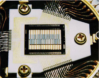 X-ray Quantum Calorimeter (XQC): Image of the XQC array mounted on a circuit board and installed in the flight detector box.  The XQC experiment is composed of a 36 pixel microcalorimeter x-ray detector. The entire array is micromachined from a single piece of silicon with each pixel measuring 0.5 x 2.0 mm.