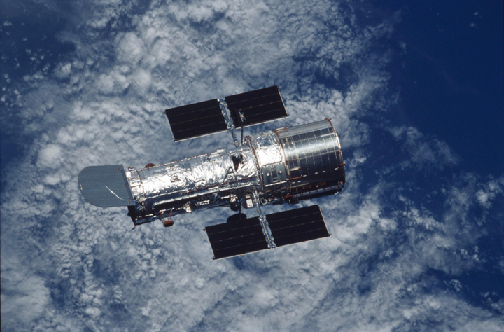 Photo of Hubble Space Telescope with the Earth in the background.