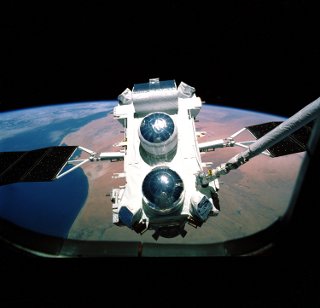 Compton Gamma Ray Observatory being released from the Shuttle: The Compton Gamma Ray Observatory was launched into orbit aboard the space shuttle Atlantis in April 1991.  The photograph was taken by a member of the shuttle crew through a window on the Atlantis shuttle as the astronauts use the shuttle arm to release the observatory into orbit.  The Earth is visible in the background.