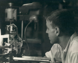 Martin Harwit, Graduate Student: Martin Harwit, as a graduate student in physics at MIT, works on a corner-cube-reflector Michelson interferometer at Block Associates, a small optical firm formed and, at the time, fully-owned by physicist Myron C. Block.